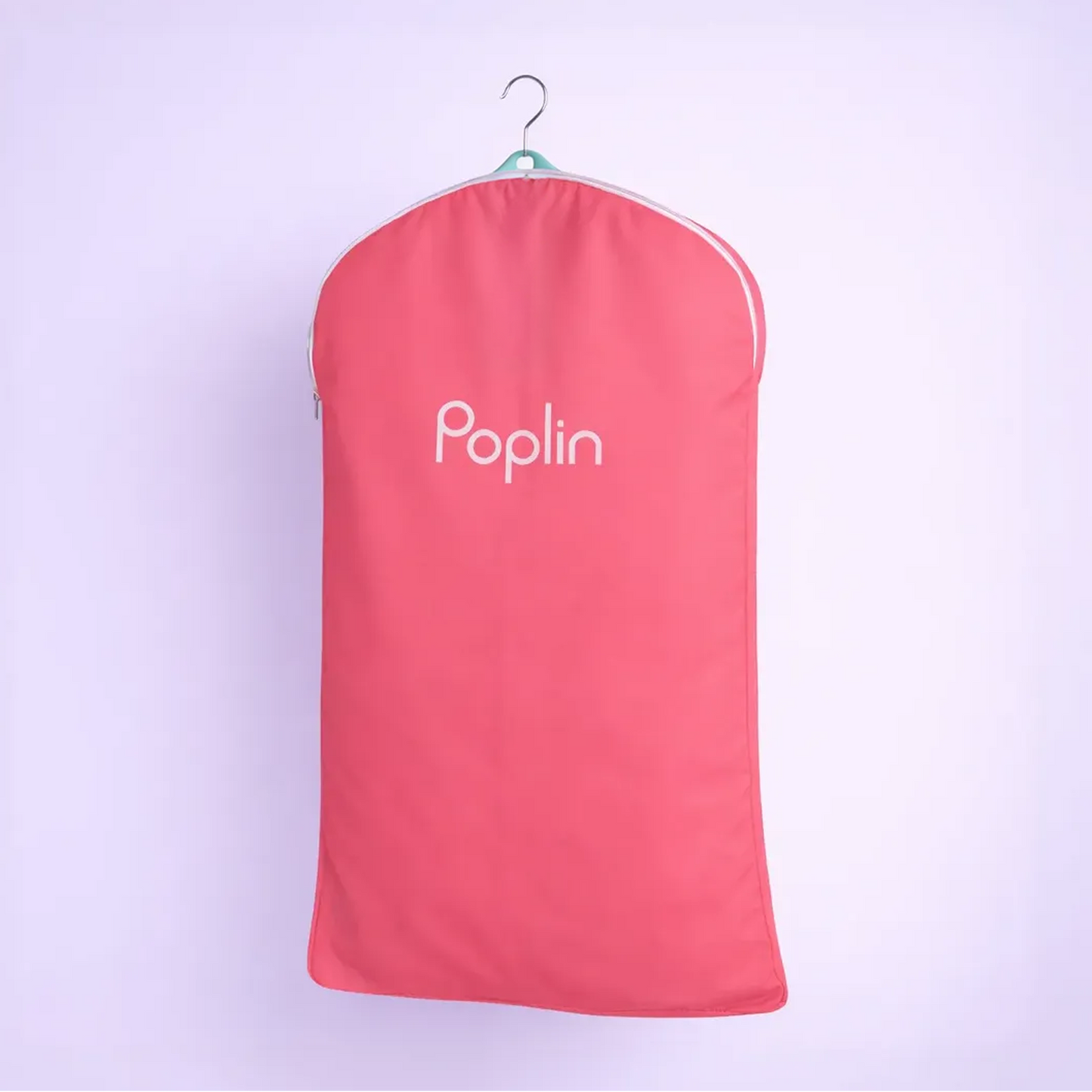 Pink Poplin dual-purpose bag holding hanging garments, demonstrating hanger delivery functionality on a studio background.