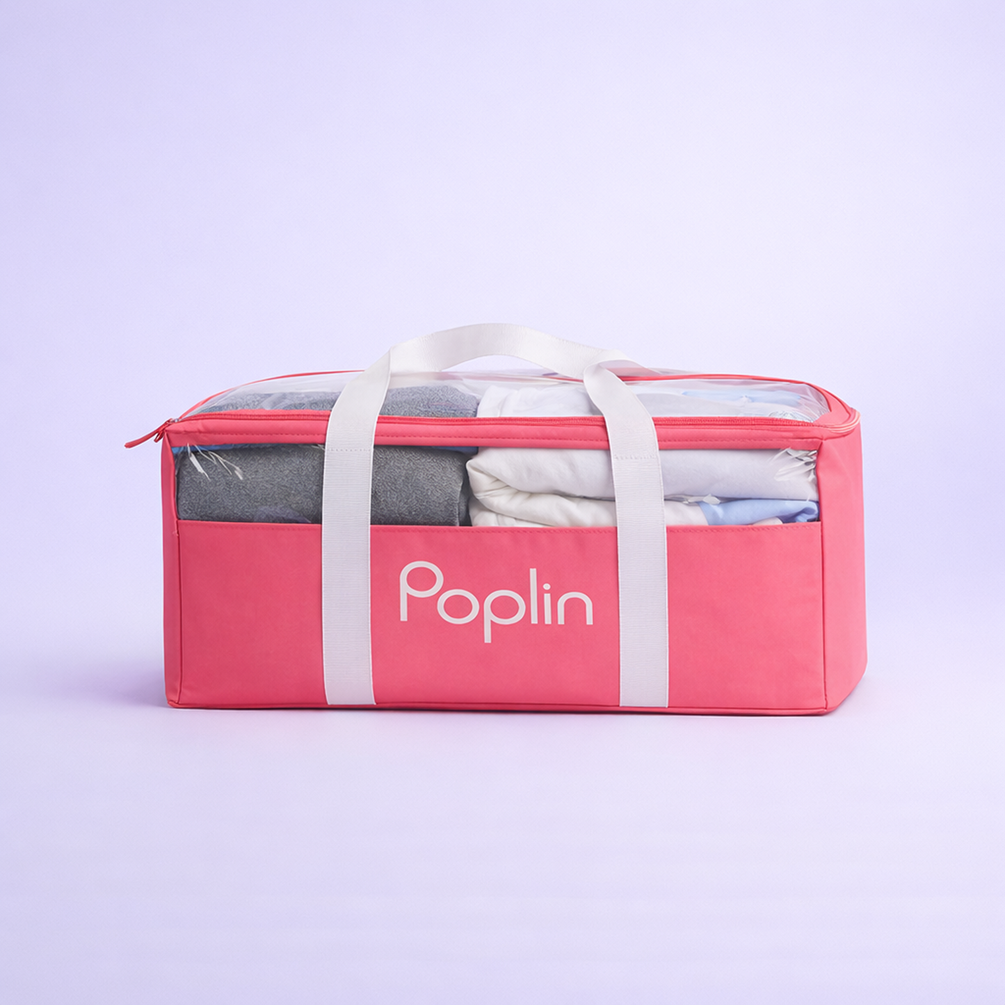 Pink Poplin delivery bag filled with neatly folded laundry, zipped closed, shown on a clean studio background.