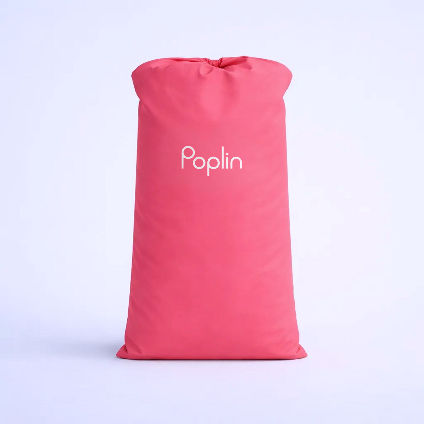 Pink Poplin dual-purpose pickup and hanger bag standing upright, filled with laundry, shown on a light studio background.