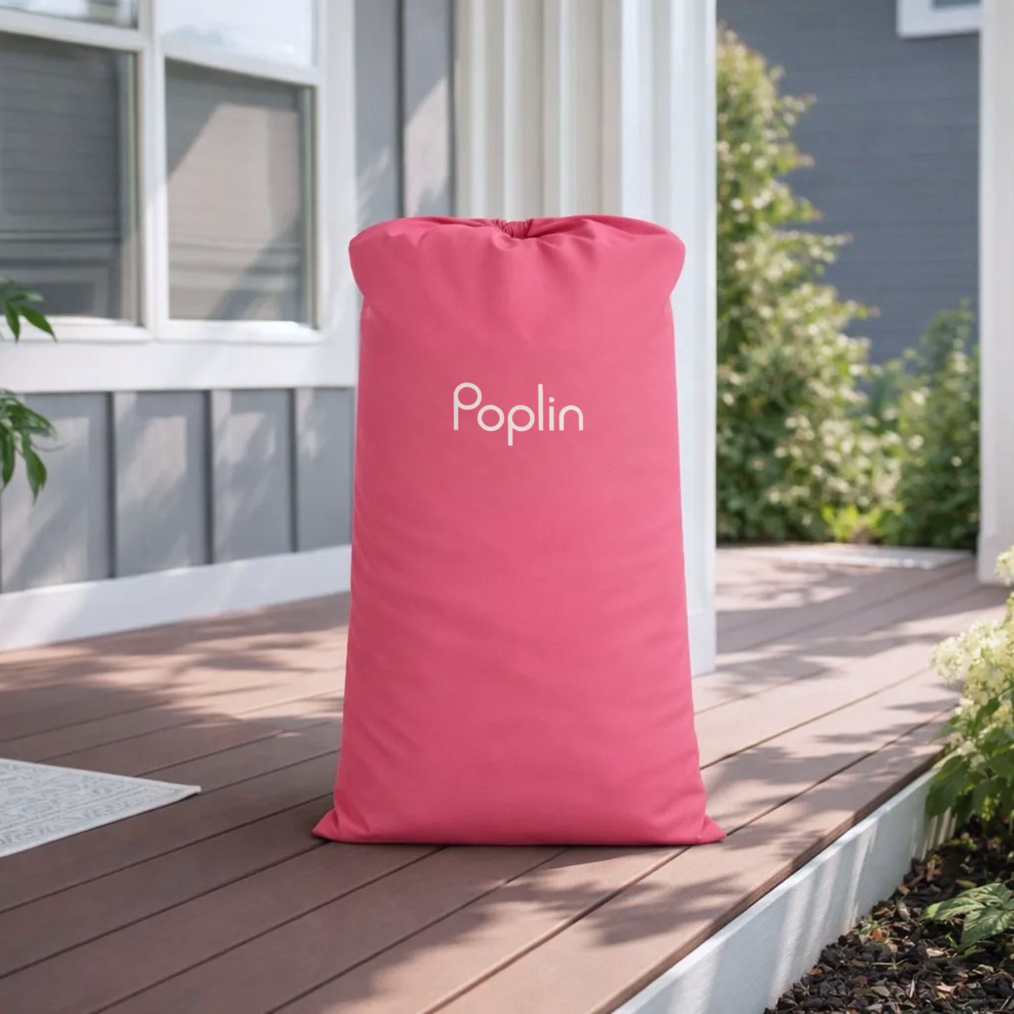 Pink Poplin dual-purpose pickup and hanger bag standing on a front porch in natural daylight.